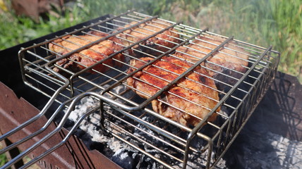Pork steaks cooked on a charcoal grill outdoors