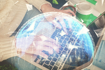 Double exposure of woman hands typing on computer and business theme hologram drawing. Success concept.