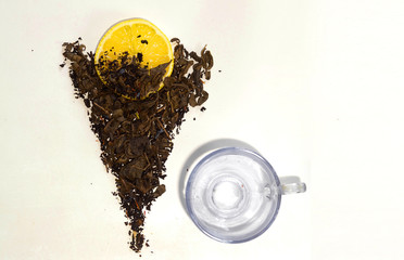 dry tea leaf and lemon on a white background