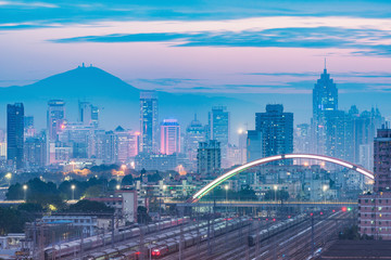 Cityscape and railway station at evening time. Shenzhen.