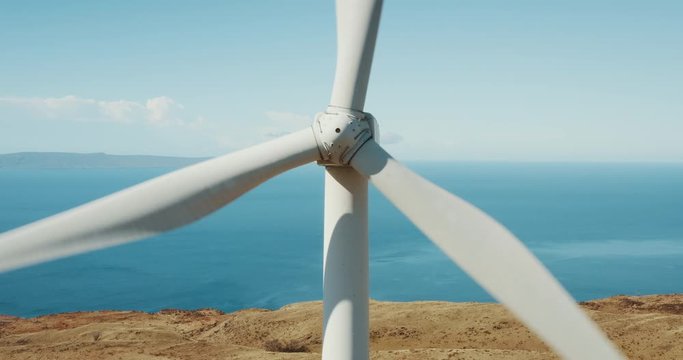 Cinematic aerial view of large wind turbine producing clean sustainable energy, green energy revolution