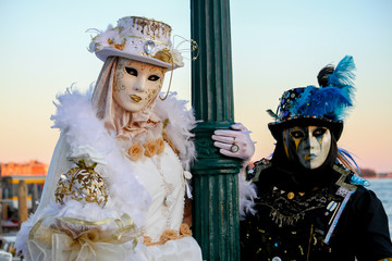 CARNIVAL OF VENICE: Pair of ladies in black and white with soft touches of light blue and gold.