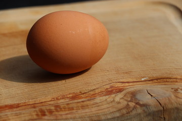 egg on wooden chopping board 