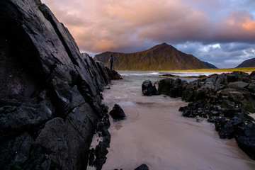 people on the beach, rocks and sand on lofoten islands