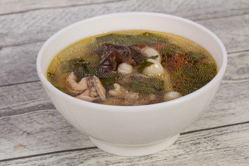 Thai style soup with meat and mushrooms