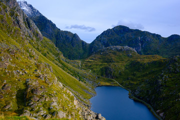 mountain lake in the Lofoten islands, alpine meadows and stones