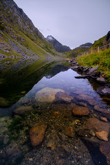 mountain lake in the Lofoten islands, alpine meadows and stones