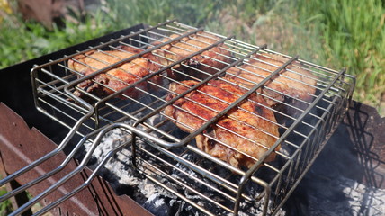 Pork steaks cooked on a charcoal grill outdoors