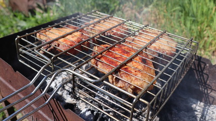 Pork steaks cooked on a charcoal grill outdoors