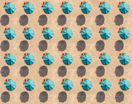 Aerial view of rows of turquoise colored beach umbrellas