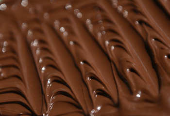 molten milk chocolate with wavy patterns