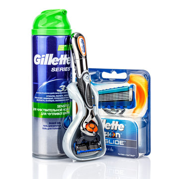 Moscow, Russia - January 23, 2020: Gillette Fusion Proglide Power battery razor handle in plastic storage case with shave gel and blister pack of razor blades on white background with reflection