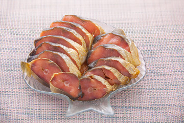 Hot smoked salmon fish on kitchen board on table
