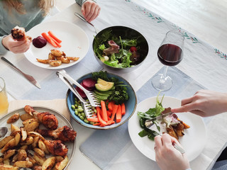 Overvew photo of healthy family dinner with baked potato and chiken and salad