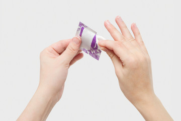Fototapeta premium Coronavirus COVID-19. Alcohol pad is use for disinfection as first aid. Wet tissue epidemic prevention, antibacterial sterilization. Cleaning hands with alcohol-based hand sanitizing antiseptic wipes