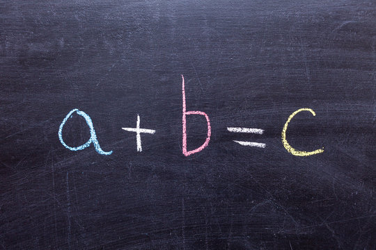 "A+B=C" handwritten with white chalk on a blackboard