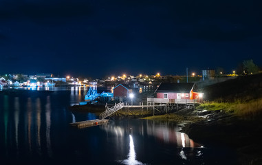 Fototapeta na wymiar view of the Reine village at night, Lofoten islands, Rorbu in the light of lanterns