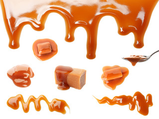 Set with caramel candies and tasty sauce on white background