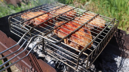 Pork steaks cooked on a charcoal grill outdoors
