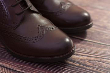new brown leather shoes with laces on a dark background