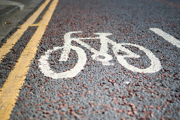 English bicycle lane sign painted on the road