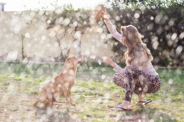 Young beautiful woman practicing yoga with her dog outdoors - 341073399