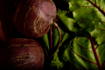 Fresh organic beetroot with their leaves on a wooden table
