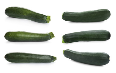 Set of fresh ripe zucchinis on white background
