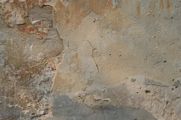 Old peeled cement wall background. Stucco texture on the wall. Cracked Cracked Rough Abstract Surface