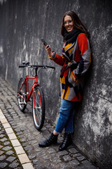 Stylish gladsome lady waiting for someone in old city