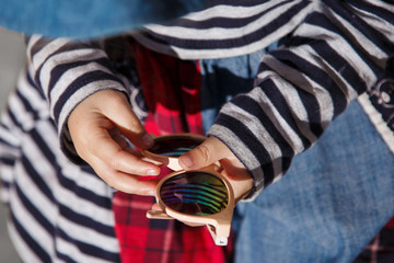 child girl holding sunglasses in her hands