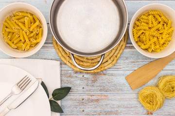 Various kind of pasta served on table with cutlery
