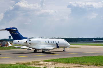 Business jet moves on taxiway to the runway