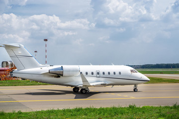 Fototapeta na wymiar Business jet moves on taxiway to the runway