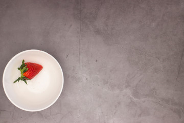 Strawberries in bowl on the table 
