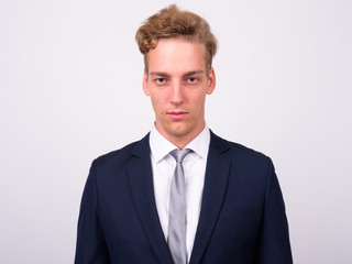 Young handsome Scandinavian businessman against white background