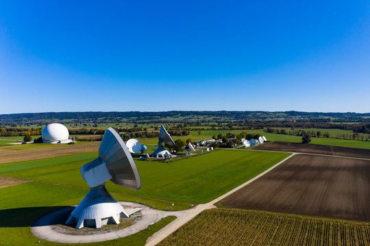 Germany, Bavaria, Aerial view of large parabolic antennas of the earth station Raisting and green fields