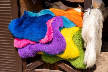 dyed colored animal fur skins on a store counter