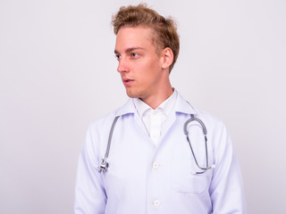 Young handsome Scandinavian man doctor against white background