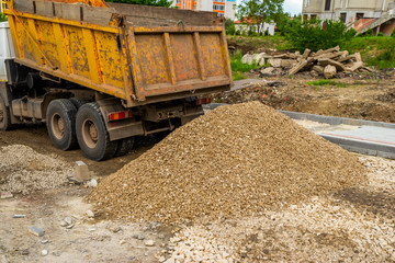 dump truck poured a bunch of rubble at the construction site
