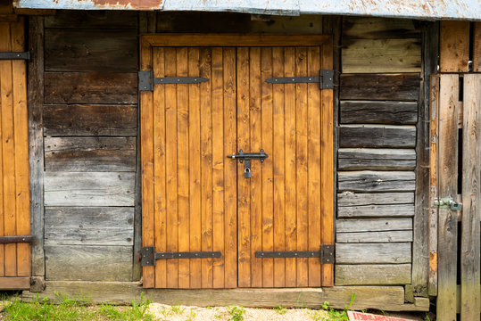wooden gate with a bolt lock in an old farm shed