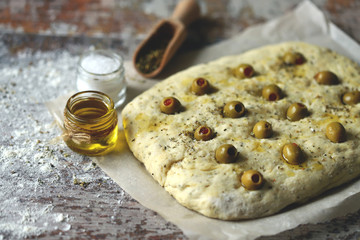Italian focacca before baking. Yeast dough. Baking at home.