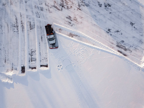 Russia, Leningrad Oblast, Tikhvin, Aerial view of snowplow clearing parking lot