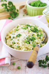 Italian cuisine. Plate of green pea risotto with green pea, parmesan cheese, olive oil and parsley