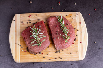 fresh raw sliced beef meat steak on a wooden board