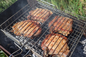 Pork steaks cooked on a charcoal grill outdoors