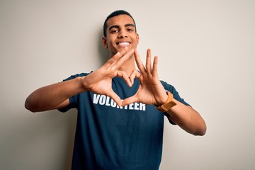 Young handsome african american man volunteering wearing t-shirt with volunteer message smiling in...