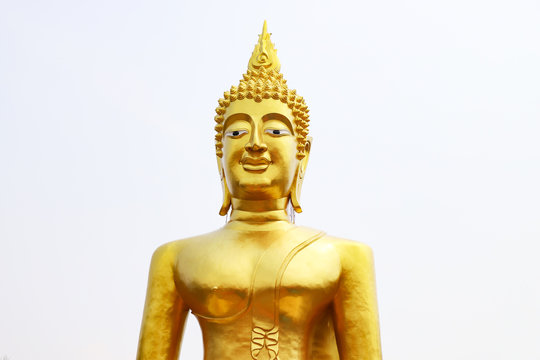 Statue of the Golden Buddha against the light sky.