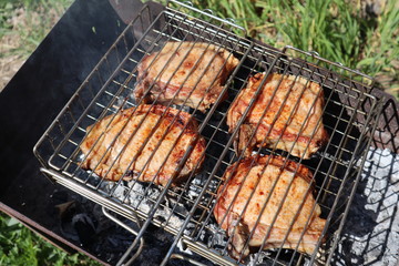 Pork steaks cooked on a charcoal grill outdoors