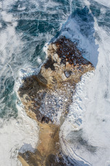 top view of the Shamanka rock in the ice of Lake Baikal